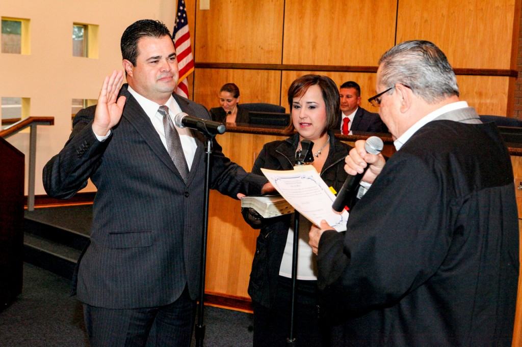Mayor Pro Tem Homer Jasso, Jr., with his wife, Belinda, holding the Bible while his father, Precinct 4, Place 2 Justice of the Peace Homer Jasso, administers the oath of office Mayor Pro Tem Homer Jasso, Jr., with his wife, Belinda, holding the Bible while his father, Precinct 4, Place 2 Justice of the Peace Homer Jasso, administers the oath of office