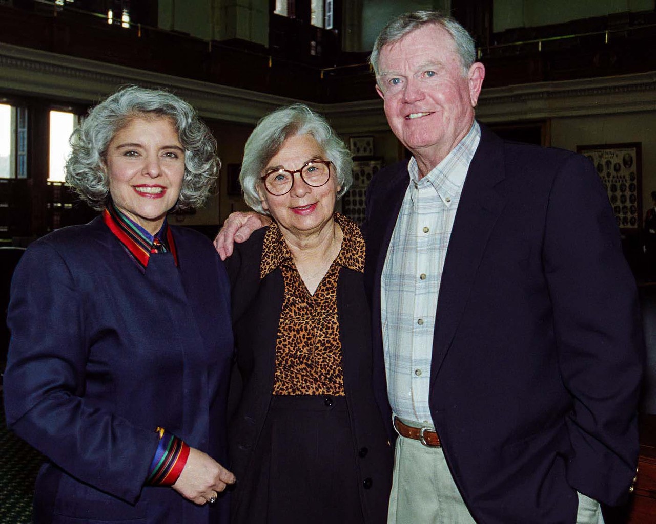 FEATURED, FROM LEFT: In this image from 1997 taken on the floor of the Senate Chamber in the Texas Capitol, Sen. Judith Zaffirini, D-Laredo/Starr County, poses with Edith Royal and her husband, legendary University of Texas Longhorns head coach Darrell Royal, during a rehearsal for her Governor for a Day Celebration. “I vividly recall him saying, ‘I know one thing for sure: her blood runs burnt orange.’ Indeed. Hook ‘em, Horns!” said Zaffirini, who has a Bachelor of Science (B.S), a Master’s of Arts (M.A.), and a Doctor of Philosophy (Ph.D.) from the University of Texas at Austin.